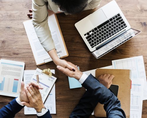 Business people shaking hands together
